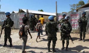 how did president clinton react when military leaders in haiti overthrew president aristide